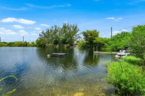 a view of a lake with houses in the back