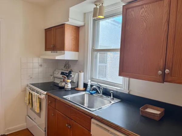 a kitchen with a sink cabinets and a window