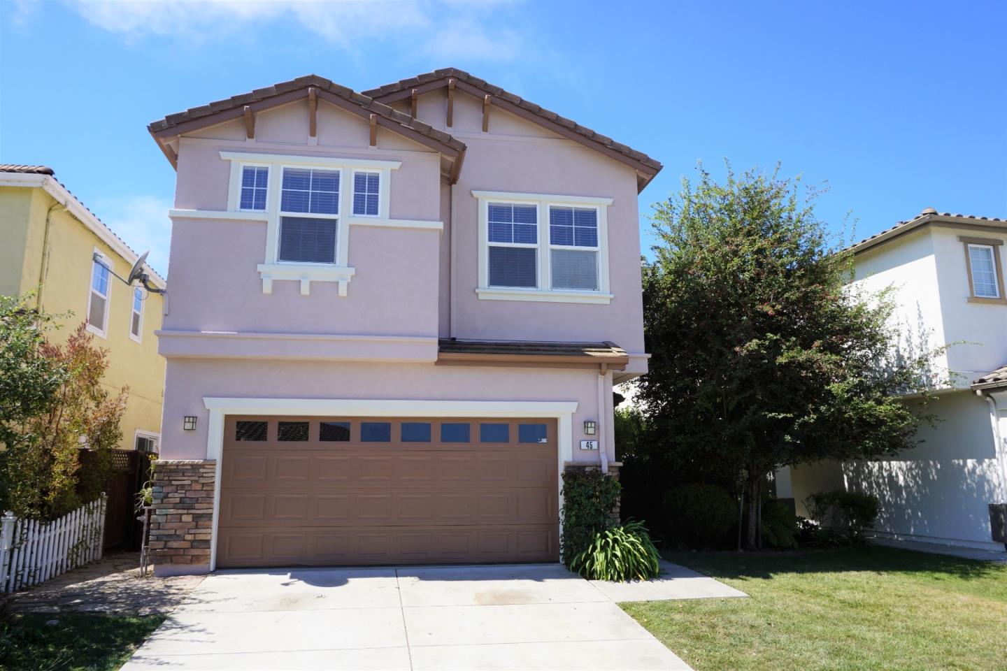a front view of a house with a yard