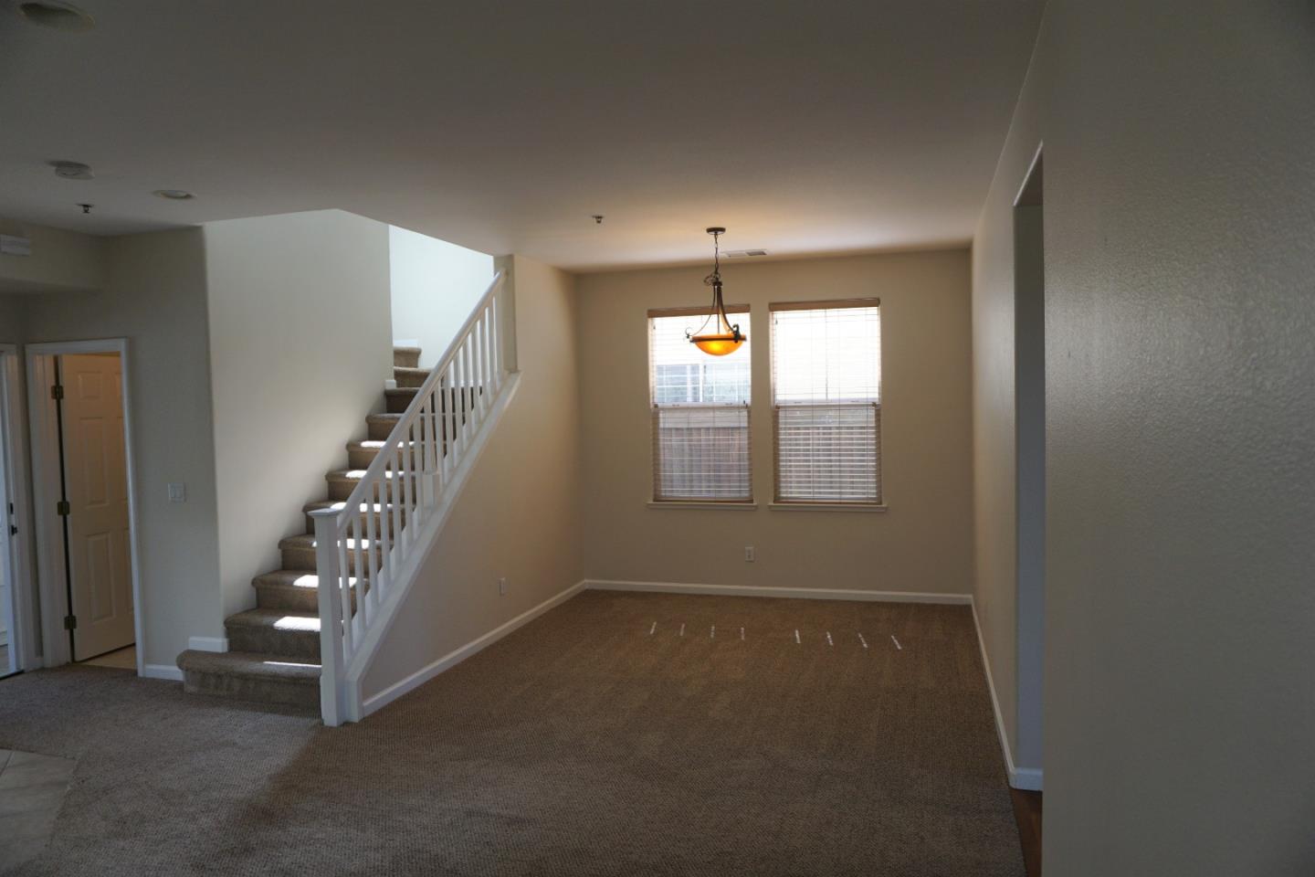 45 Pelican Drive Watsonville, CA 95076 - Photo 3 of 21 a view of an empty room with stairs and chandelier fan