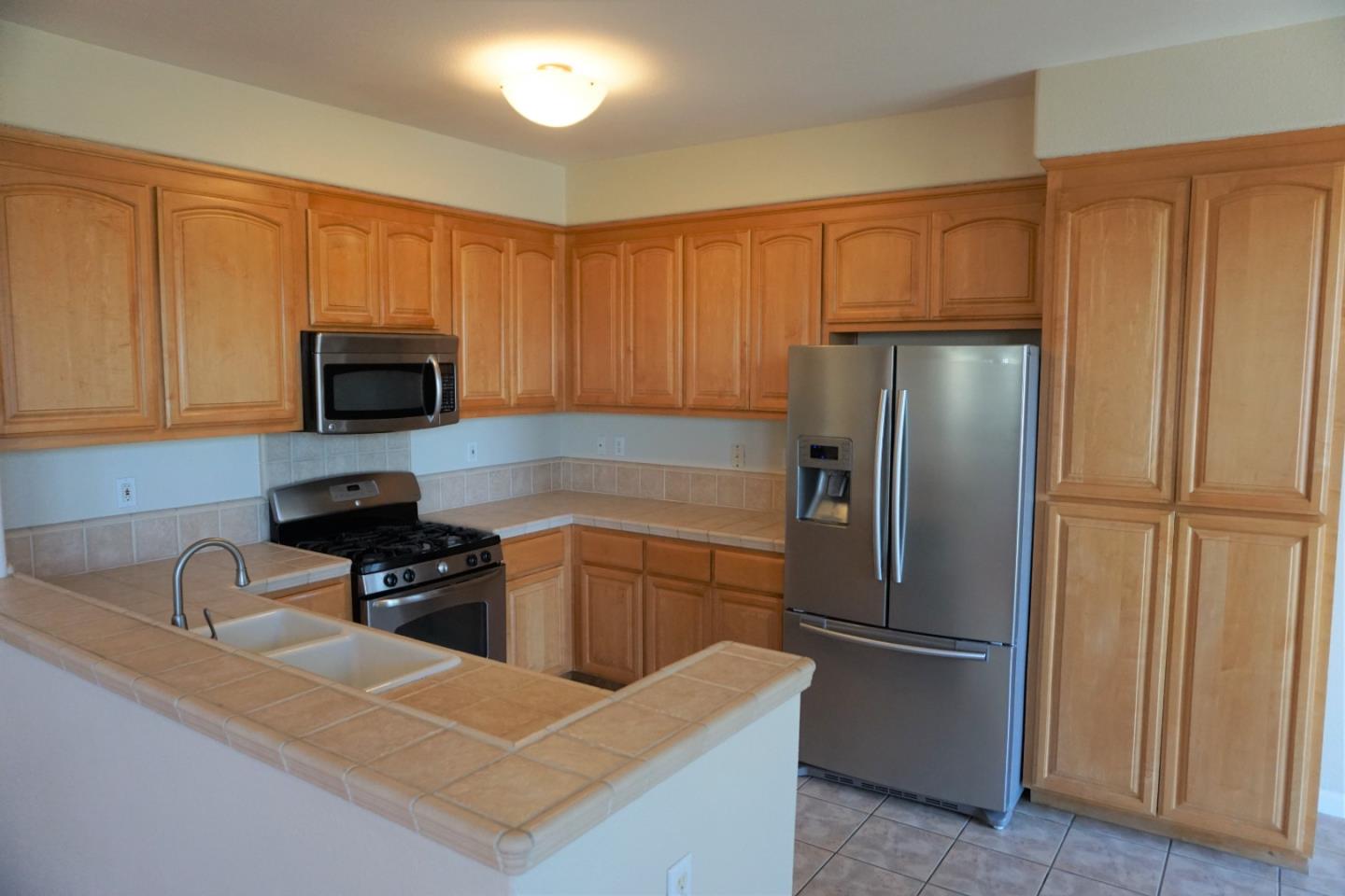 45 Pelican Drive Watsonville, CA 95076 - Photo 9 of 21 a kitchen with stainless steel appliances granite countertop a refrigerator stove a sink and dishwasher