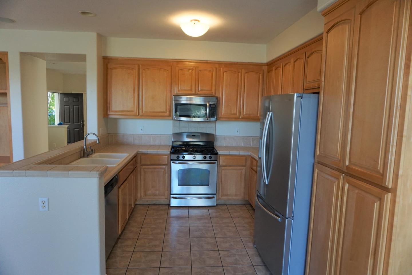 45 Pelican Drive Watsonville, CA 95076 - Photo 10 of 21 a kitchen with stainless steel appliances granite countertop a refrigerator stove and sink