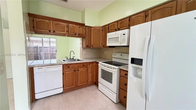 a kitchen with stainless steel appliances a stove a microwave and a refrigerator