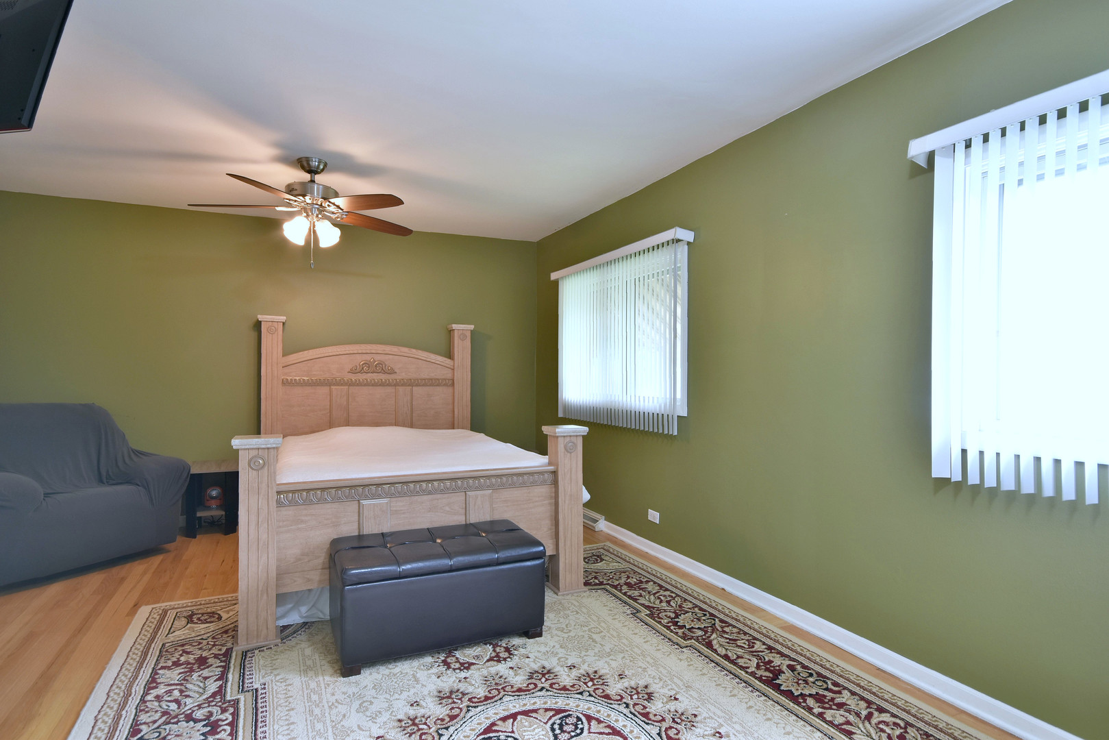 1042 North Wheeling Road, Unit 1042 Mount Prospect, IL 60056 - Photo 13 of 32 a bedroom with a bed and a chandelier