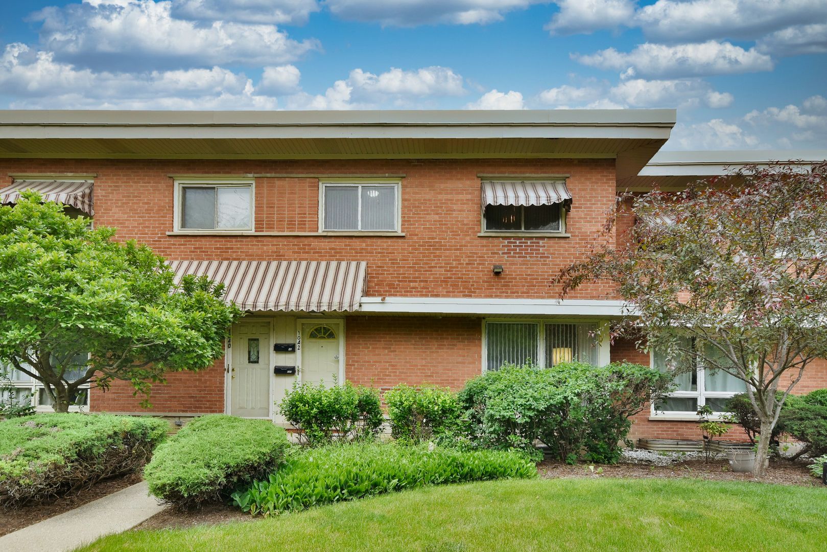 1042 North Wheeling Road, Unit 1042 Mount Prospect, IL 60056 - Photo 28 of 32 a front view of a house with a yard