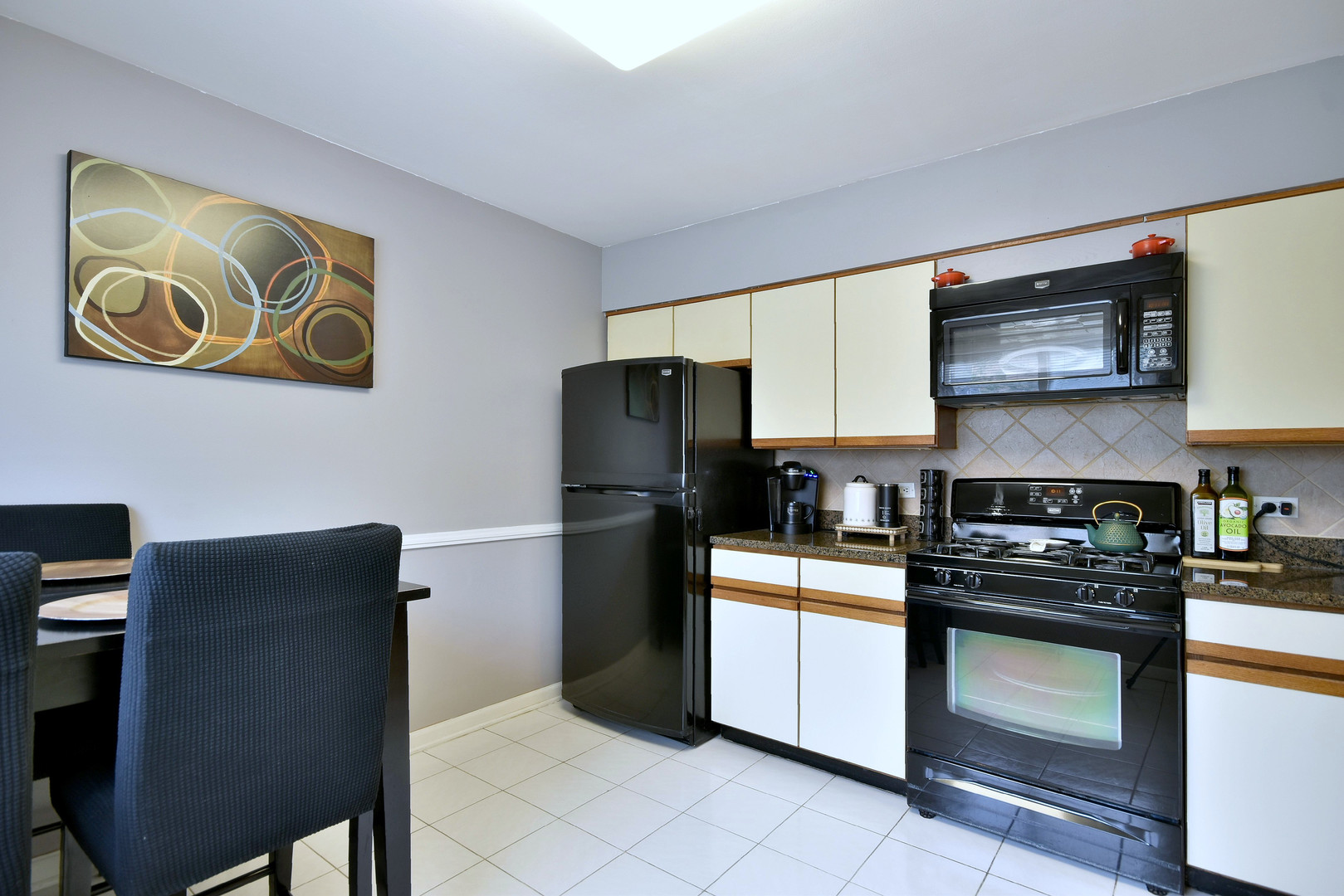 1042 North Wheeling Road, Unit 1042 Mount Prospect, IL 60056 - Photo 8 of 32 a kitchen with stainless steel appliances granite countertop a refrigerator sink and stove