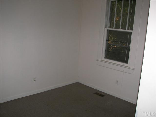 4031 Greenleaf Street, Unit 2 Raleigh, NC 27606 - Photo 10 of 13 an empty room with a window