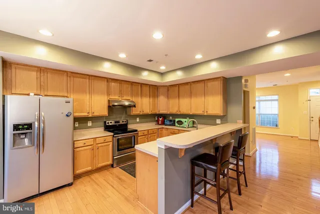 a kitchen with a sink a counter top stainless steel appliances and cabinets