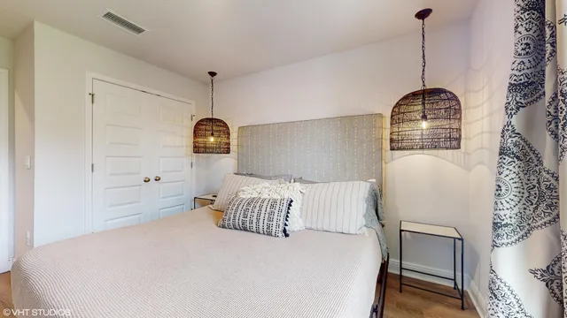 a bedroom with a bed and a chandelier
