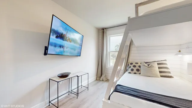 a living room with couch and a painting on the wall