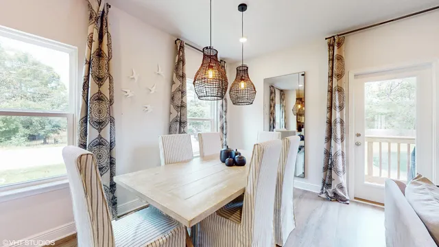 a view of a dining room with furniture window and wooden floor