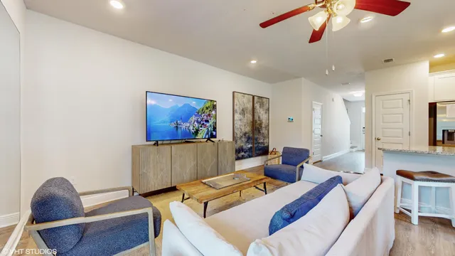a living room with furniture and a flat screen tv