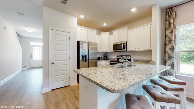 a kitchen with granite countertop stainless steel appliances and wooden cabinets
