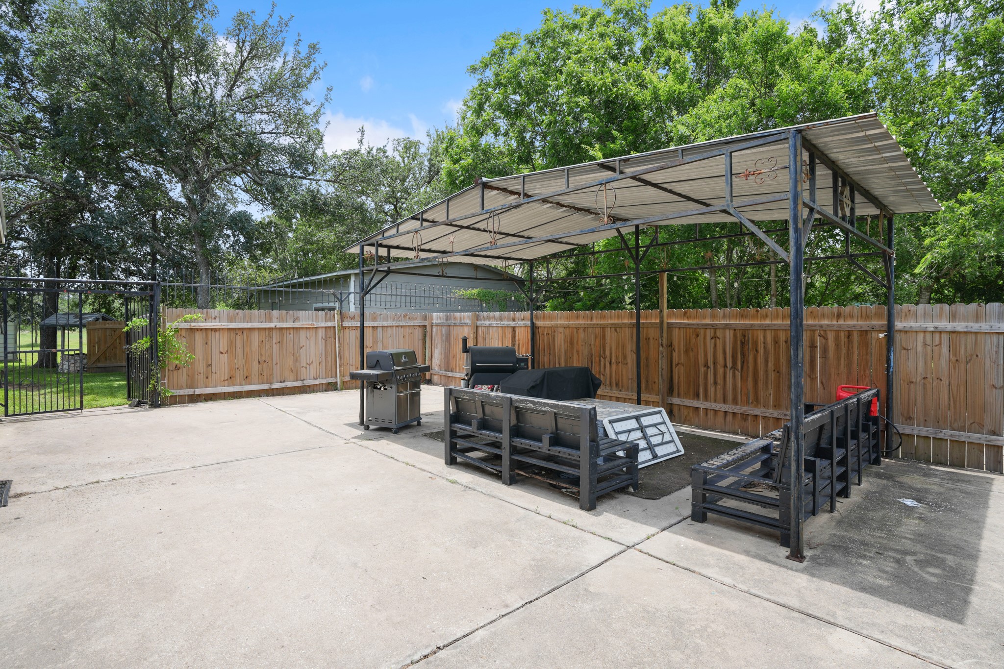 9725 Bock Road Buda, TX 78610 - Photo 27 of 32 A spacious backyard patio area, perfect for outdoor entertaining, with a large covered pergola.