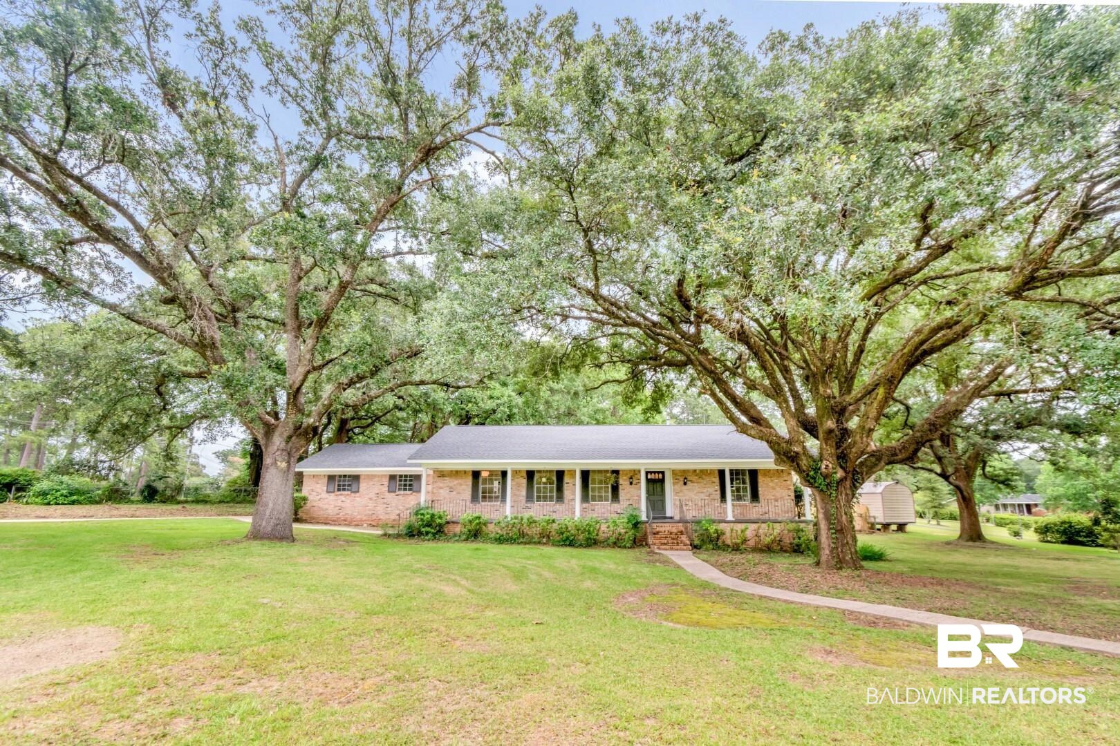 5217 Perin Road Mobile, AL 36693 - Photo 42 of 45 Brick ranch-style residence featuring a dark shingle roof, white porch columns, and dark window shutters