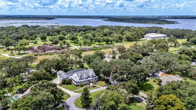 a view of a house with a yard and lake view