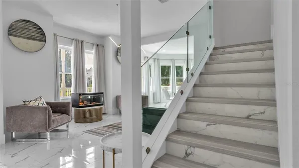 a living room with furniture large window and couch
