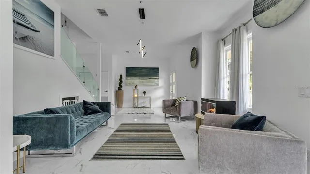 a living room with furniture and large windows