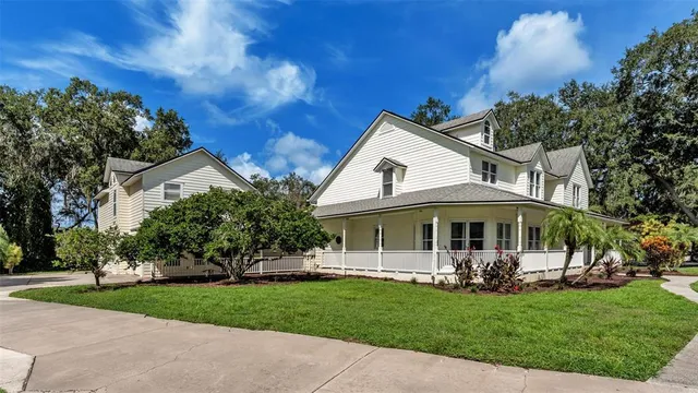 a living room with furniture a fireplace and a chandelier