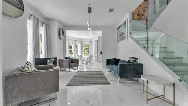 a kitchen with kitchen island granite countertop a sink and refrigerator