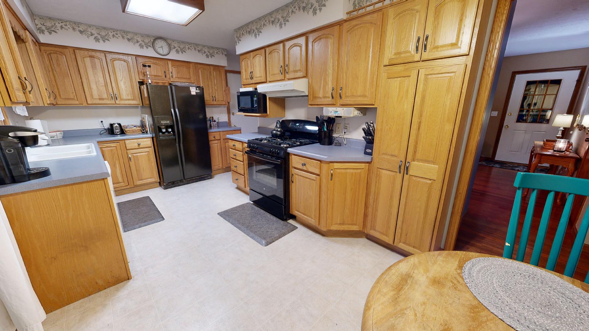 902 Charlotte Drive Normal, IL 61761 - Photo 4 of 35 a kitchen with a refrigerator a stove top oven a sink and dishwasher