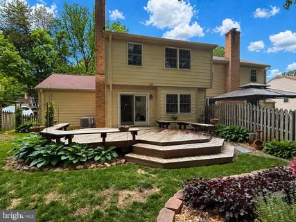 a view of a house with backyard and sitting area