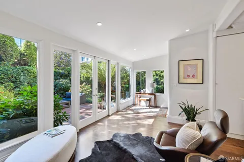 a bedroom with furniture and a potted plant