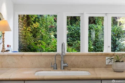 a bathroom with a sink toilet and a window