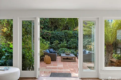 a living room with furniture and a potted plant
