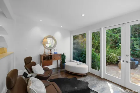a bedroom with furniture and a potted plant