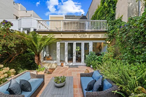 a bathroom with a double vanity sink a large mirror and a shower