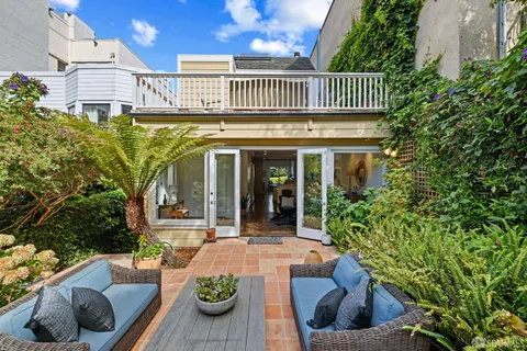 a bathroom with a tub a double vanity sink and mirror