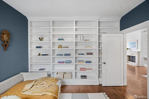 a bedroom with a bed and a desk