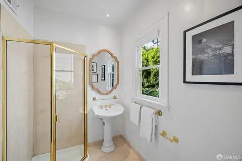 a view of a hallway with paintings on the wall