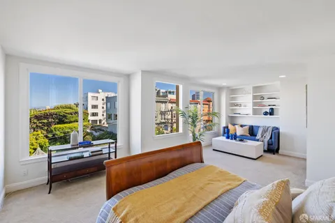 a bedroom with a large bed and a window