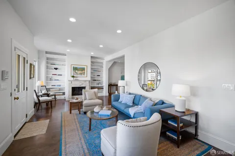 a dining room with furniture and wooden floor