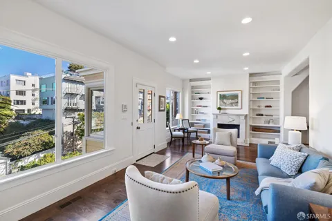 a kitchen with kitchen island a stove a table and chairs in it