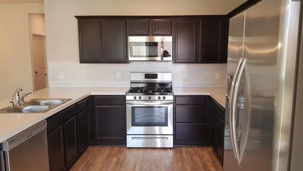 a kitchen with a refrigerator and a sink