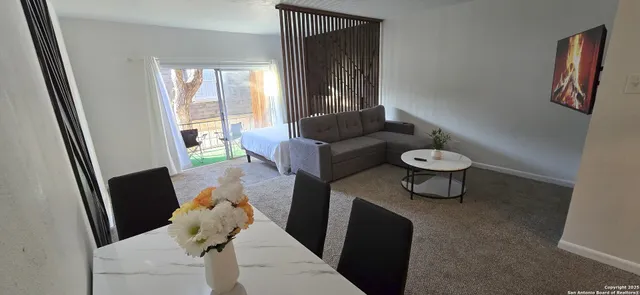 a living room with furniture and a window