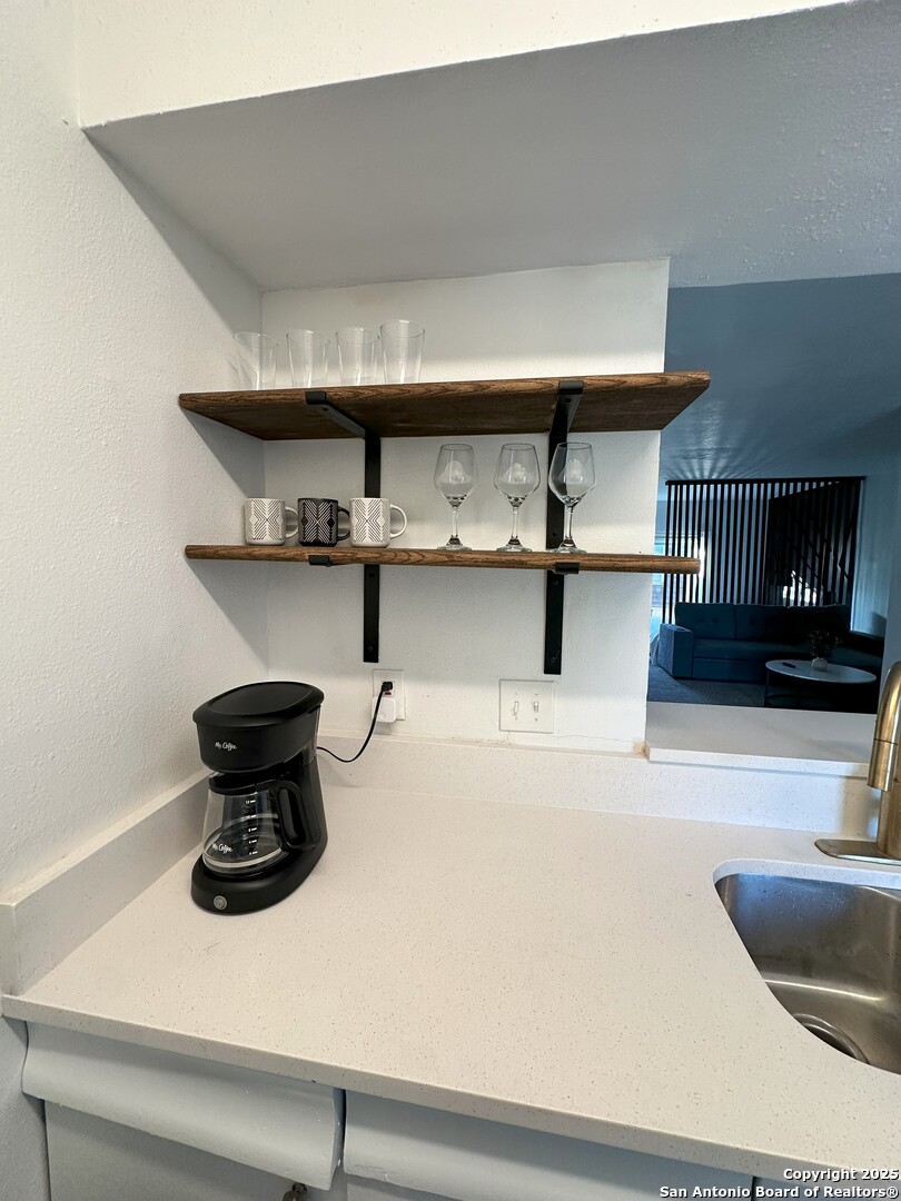 170 De Chantle Road, Unit 609 San Antonio, TX 78201 - Photo 18 of 20 a kitchen with a stove and a microwave