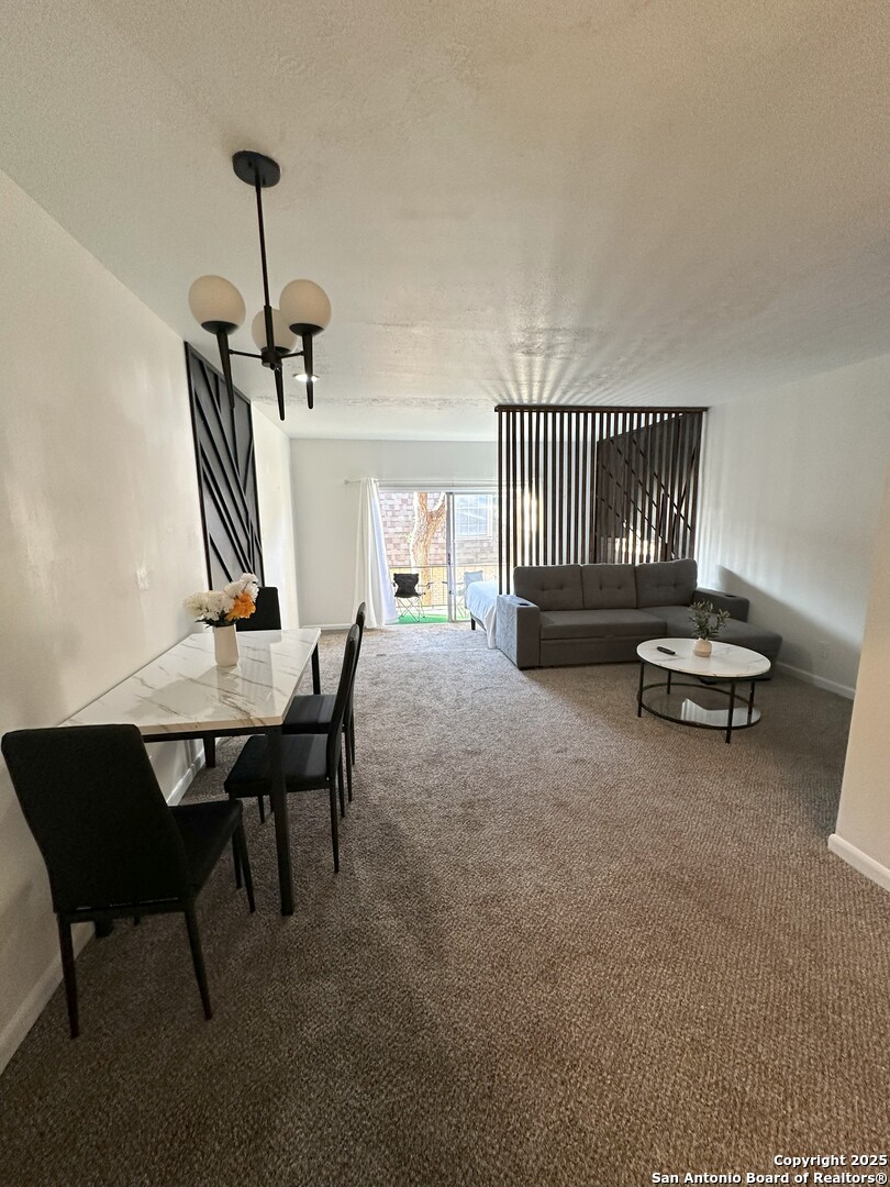 170 De Chantle Road, Unit 609 San Antonio, TX 78201 - Photo 6 of 20 a living room with furniture a piano and a window