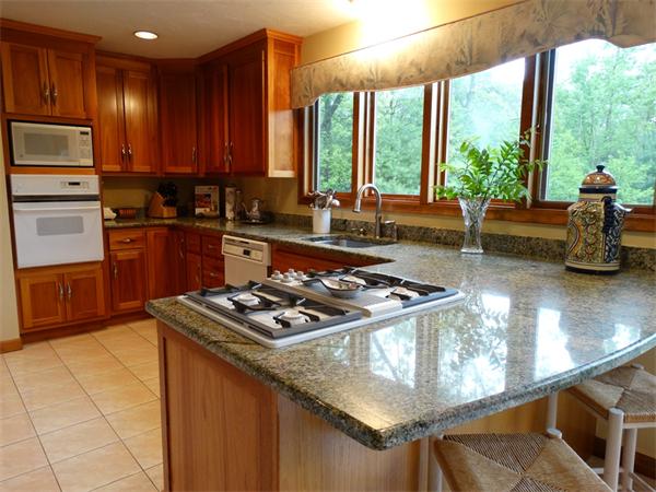 17 Grover Road Ashland, MA 01721 - Photo 7 of 26 a kitchen with a stove a sink and a refrigerator