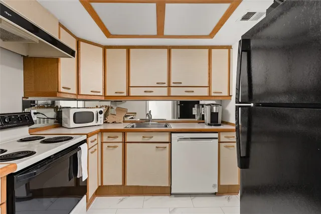 a kitchen with a sink stove and cabinets