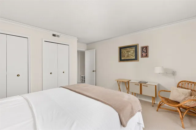 a bedroom with a bed and chair