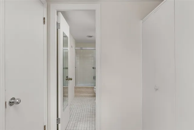 a bathroom with a glass shower door