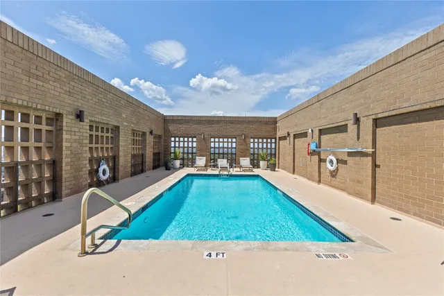 a view of a house with swimming pool in front of it