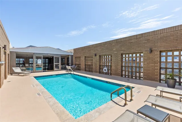 a view of a house with swimming pool and porch