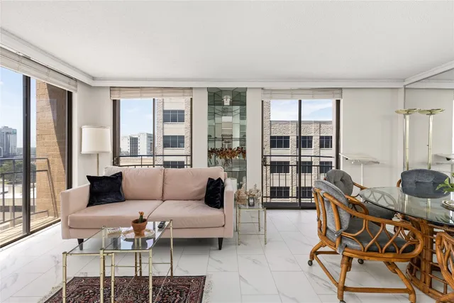 a living room with furniture and a floor to ceiling window