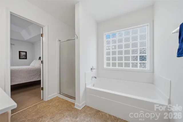 a view of backyard with a car parked in front of it