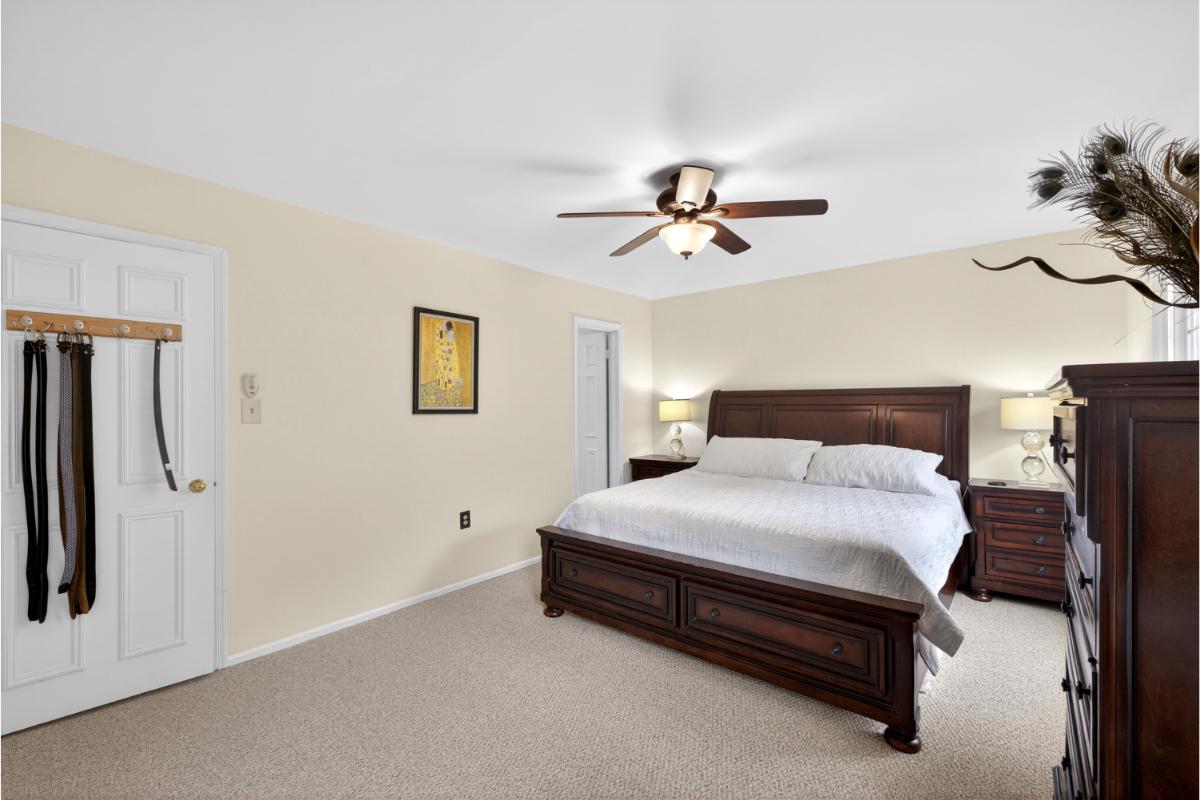 7347 Swan Point Way, Unit 122 Columbia, MD 21045 - Photo 24 of 54 a bedroom with a bed and a chandelier